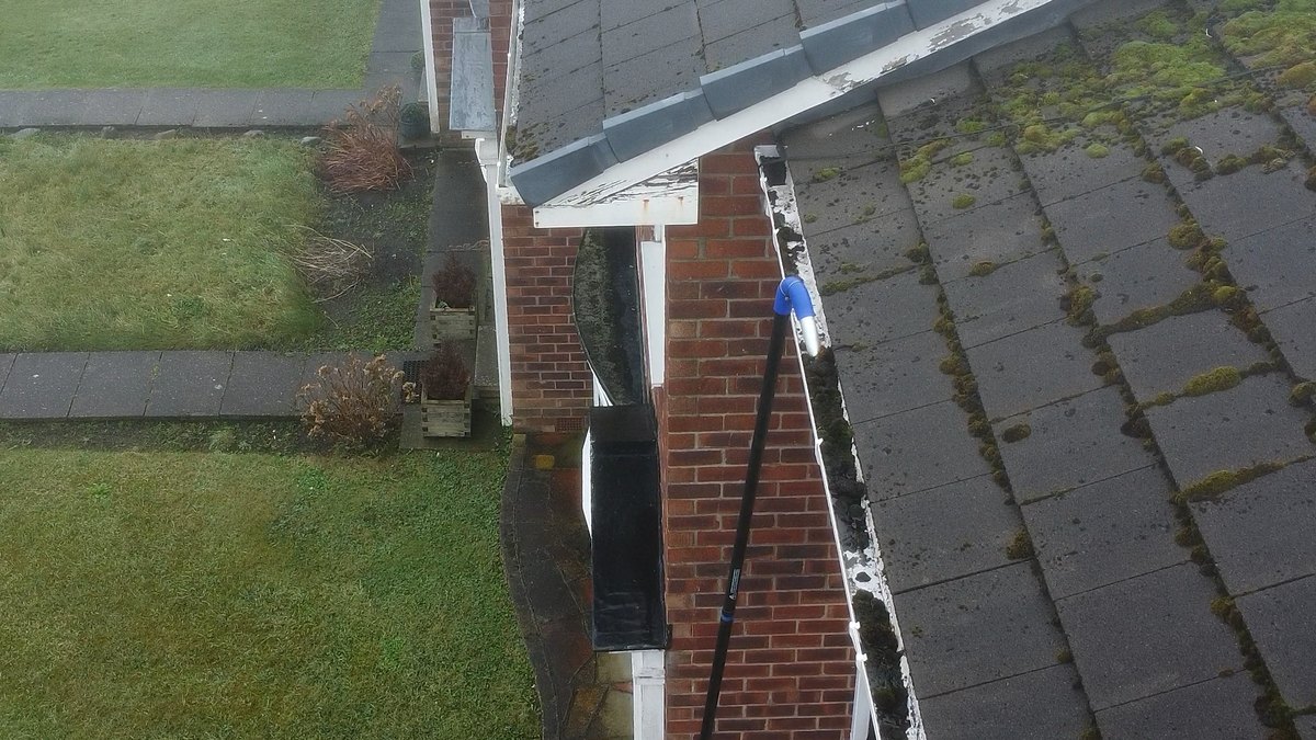 Seen from the drone, debris drawn out of the gutter line along the roof edge in Crossens