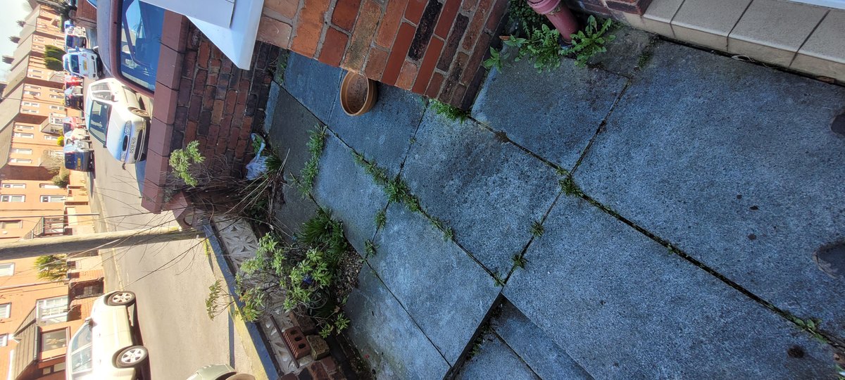 Worn and open joints between stone flags in Eccleston, St Helens, before being raked out and renewed