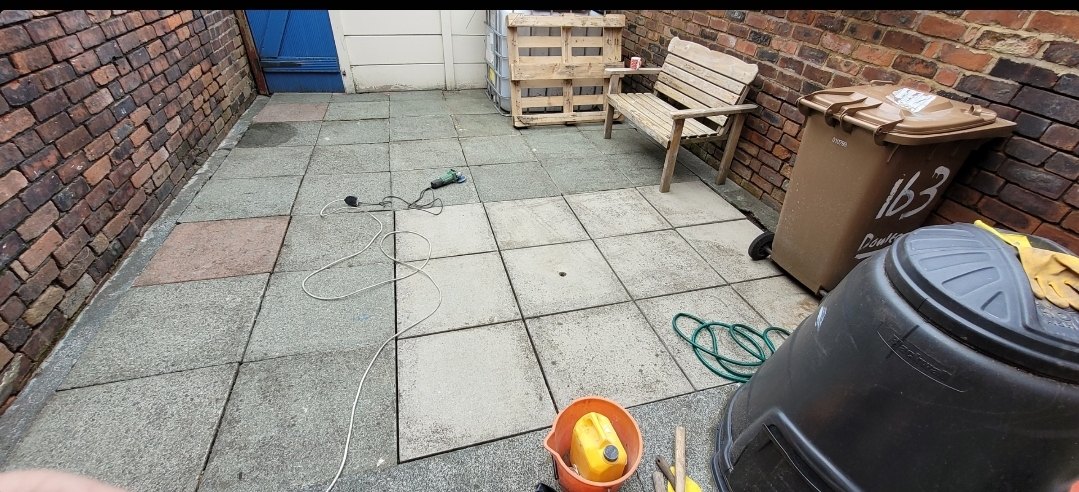 The same rear yard in Eccleston after work, the patio flags repointed and the garden wall pointed back up