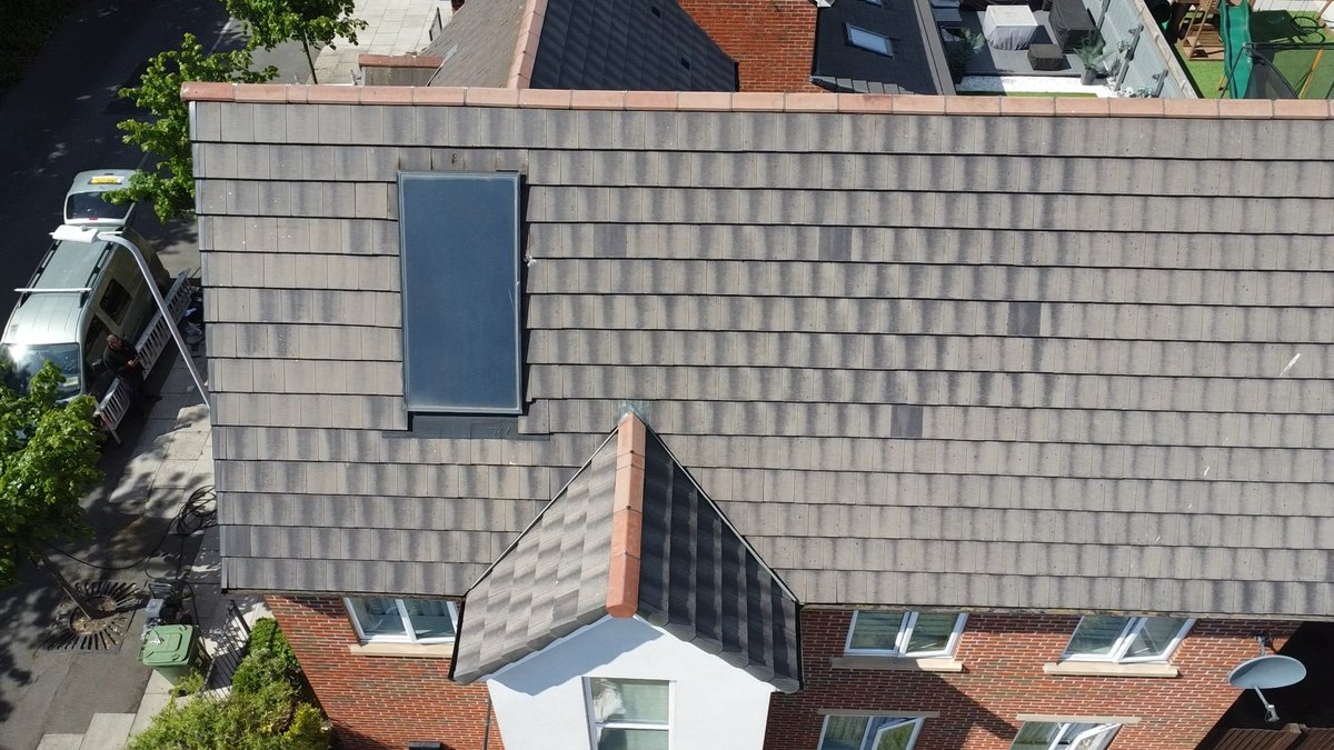 The same Bootle roof photographed from the drone after cleaning, the tiles an even grey and the solar panel untouched